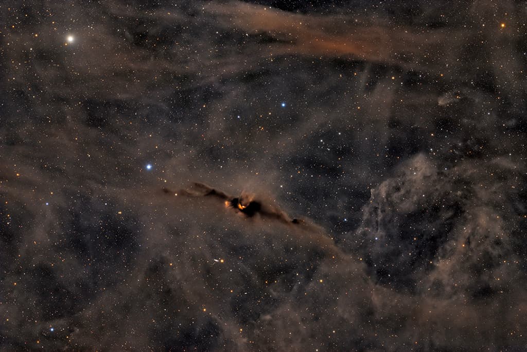 The Red Glow of the Cosmic Bat Nebula